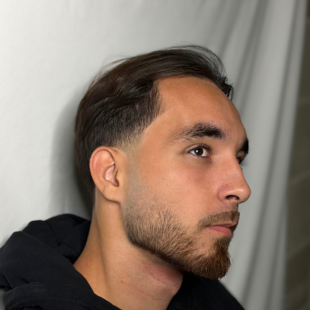 Taper fade with a swept back top and beard